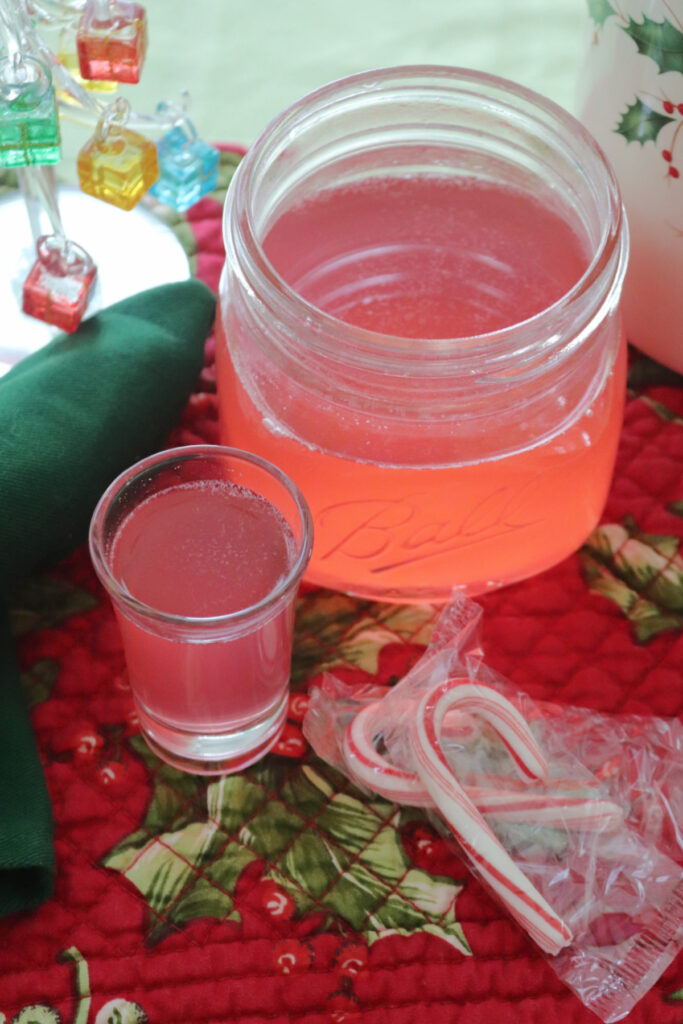 Peppermint vodka in a shot glass and jar as viewed from overhead.