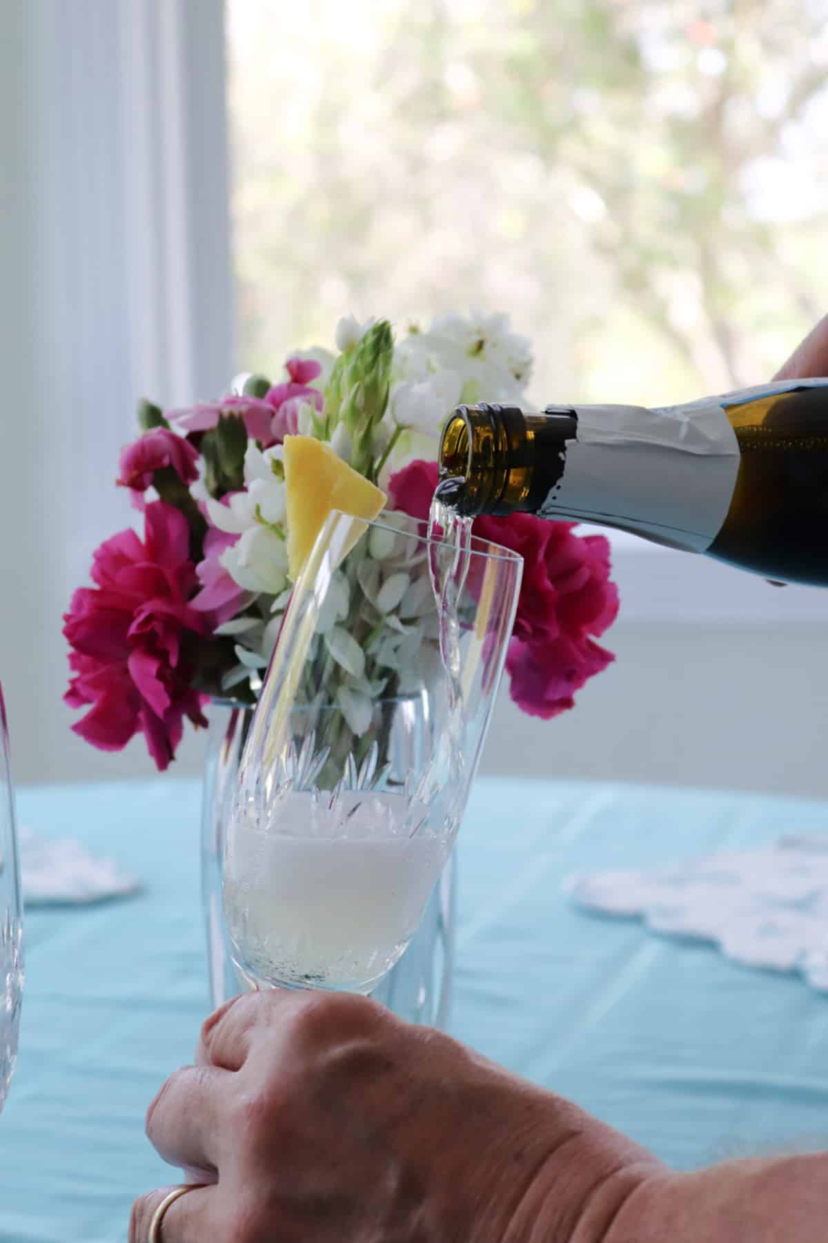 Pouring prosecco into a champagne flute.